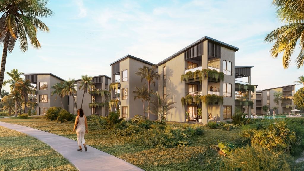 Residential buildings at The Reef surrounded by tropical vegetation